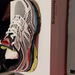 Saucony White and Black Running Shoe with Blue and Yellow Accents